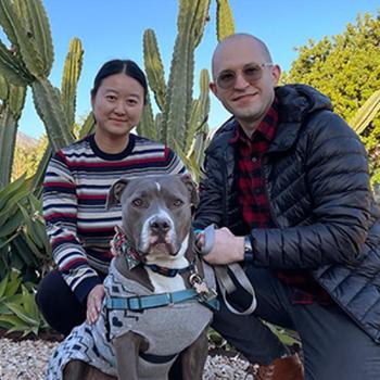 Couple sitting outdoors with dog Cannoli