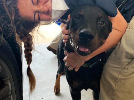 Smiling woman hugging a dog