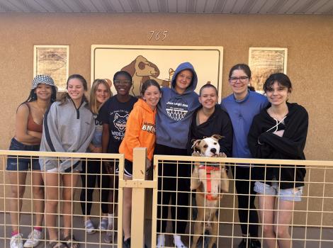 Girl Scout Troop 1019 together at Best Friends Animal Sanctuary with a dog