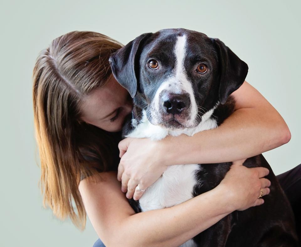 Woman hugging dog