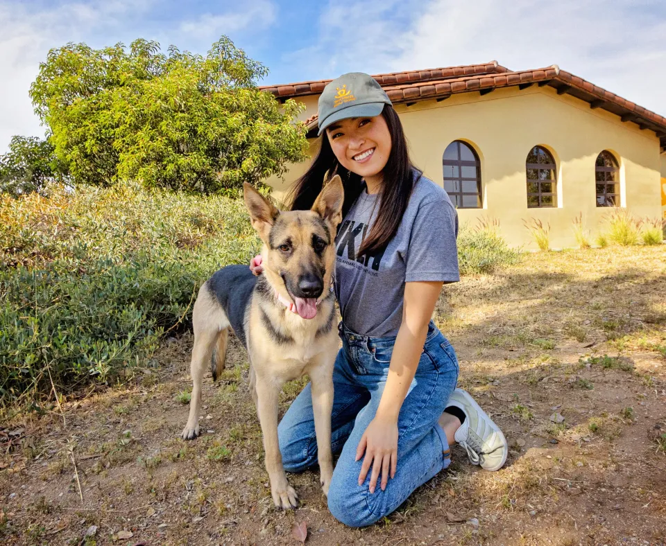 Smiling person next to a dog outside in Los Angeles