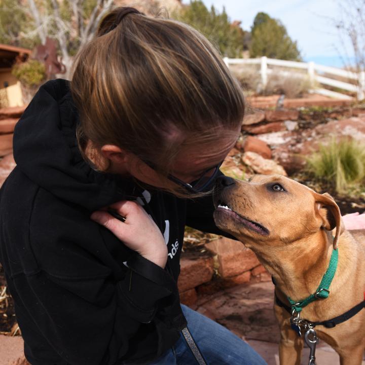 Person and dog outside of the Best Friends Welcome Center