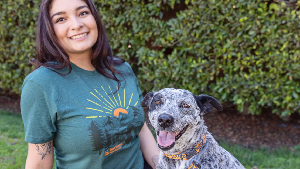 Smiling person next to a smiling dog