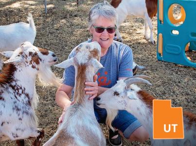 Woman petting goats