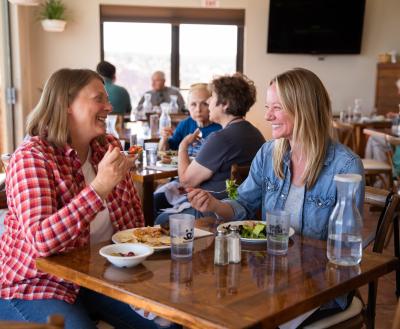 Two smiling people eating lunch at the Village Cafe at Best Friends Animal Sanctuary