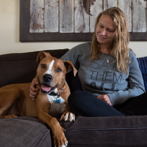 foster mom sitting with her foster dog