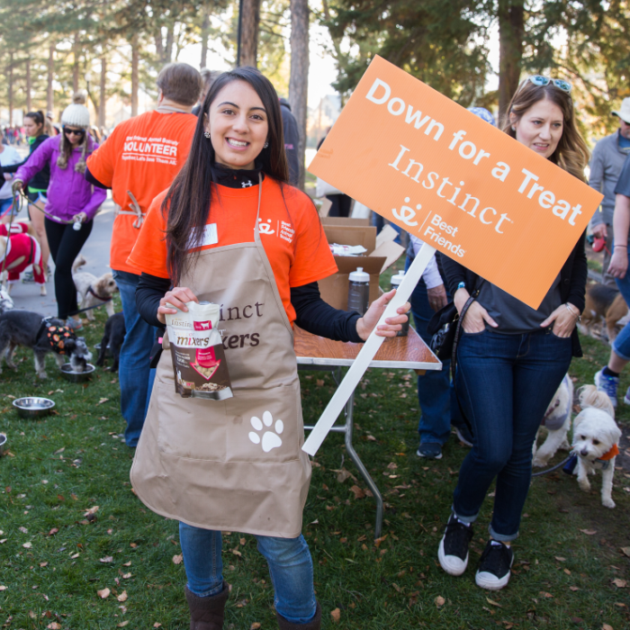 Girl holding a Strut Your Mutt sign at Best Friends